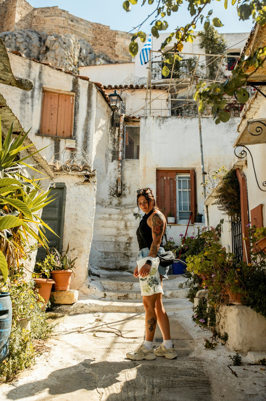 Smiling young Polish woman traveler with a backpack in a historic European old town square